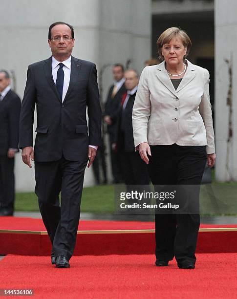 German Chancellor Angela Merkel welcomes French President Francois Hollande at the Chancellery hours after Hollande's inauguration in Paris on May...