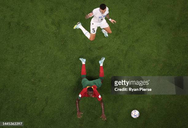 Matias Vecino of Uruguay competes for the ball against Nuno Mendes of Portugal during the FIFA World Cup Qatar 2022 Group H match between Portugal...