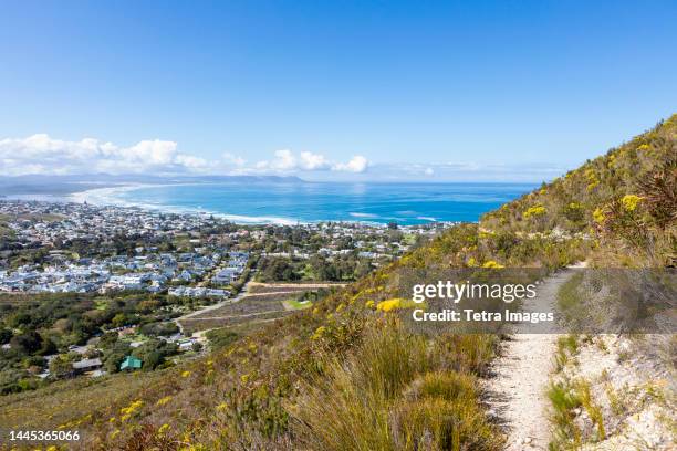 south africa, hermanus, town and sea coast seen from hiking trail - hermanus stock-fotos und bilder