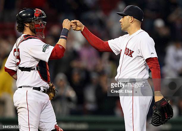 Jarrod Saltalamacchia and Alfredo Aceves of the Boston Red Sox celebrate the win over the Seattle Mariners on May 15, 2012 at Fenway Park in Boston,...