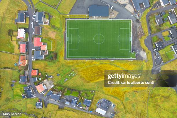 aerial vertical view taken by drone of football court near to eidi village, eysturoy, faroe island, denmark, europe - aerial view of football field stockfoto's en -beelden