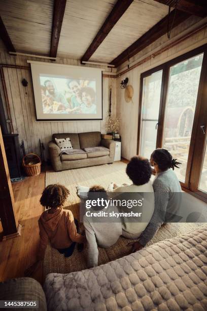 movie time at home! - family watching tv from behind stock pictures, royalty-free photos & images