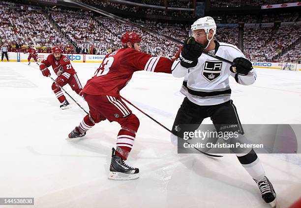 Derek Morris of the Phoenix Coyotes plays the body on Jeff Carter of the Los Angeles Kings in the first period of Game Two of the Western Conference...