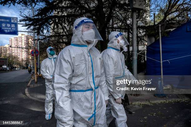 Epidemic control workers wear PPE to prevent the spread of COVID-19 as they walk in an area where communities are in lockdown on November 29, 2022 in...