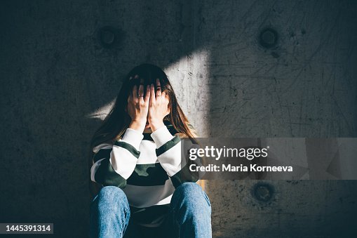 Sad woman sits alone in the city. Sad woman sits alone in the city.