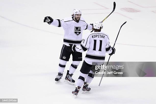 Drew Doughty of the Los Angeles Kings skates toward teammate Anze Kopitar after Kopitar assisted on a goal by teammate Jeff Carter in the second...