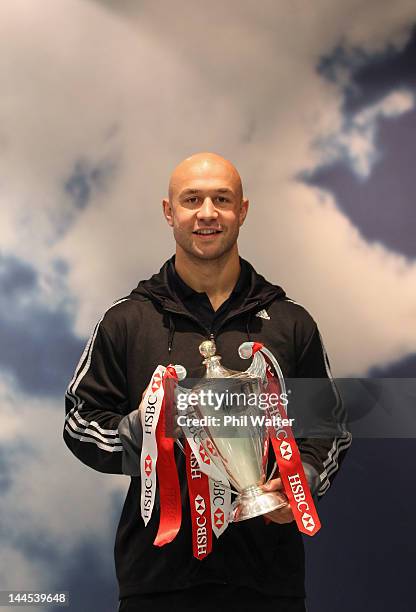 New Zealand Sevens captain DJ Forbes poses with the Sevens World Series Trophy upon their arrival home at Auckland International Airport on May 16,...