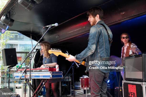 Jeanette Stewart, Tyson McShane and Paul Ross of Slow Down, Molasses perform on stage at the Dr Martins street gig airstream trailor during The Great...