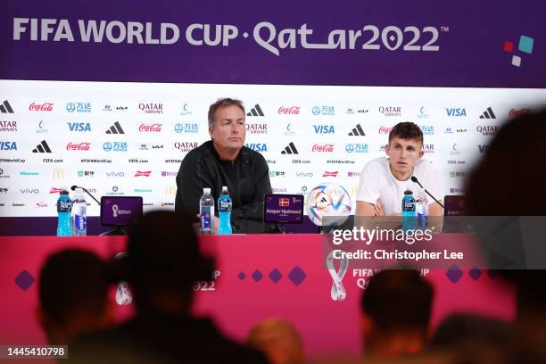 Kasper Hjulmand, Head Coach of Denmark, and Jesper Lindstrom of Denmark speak during the Denmark Press Conference at the main Media Center on...