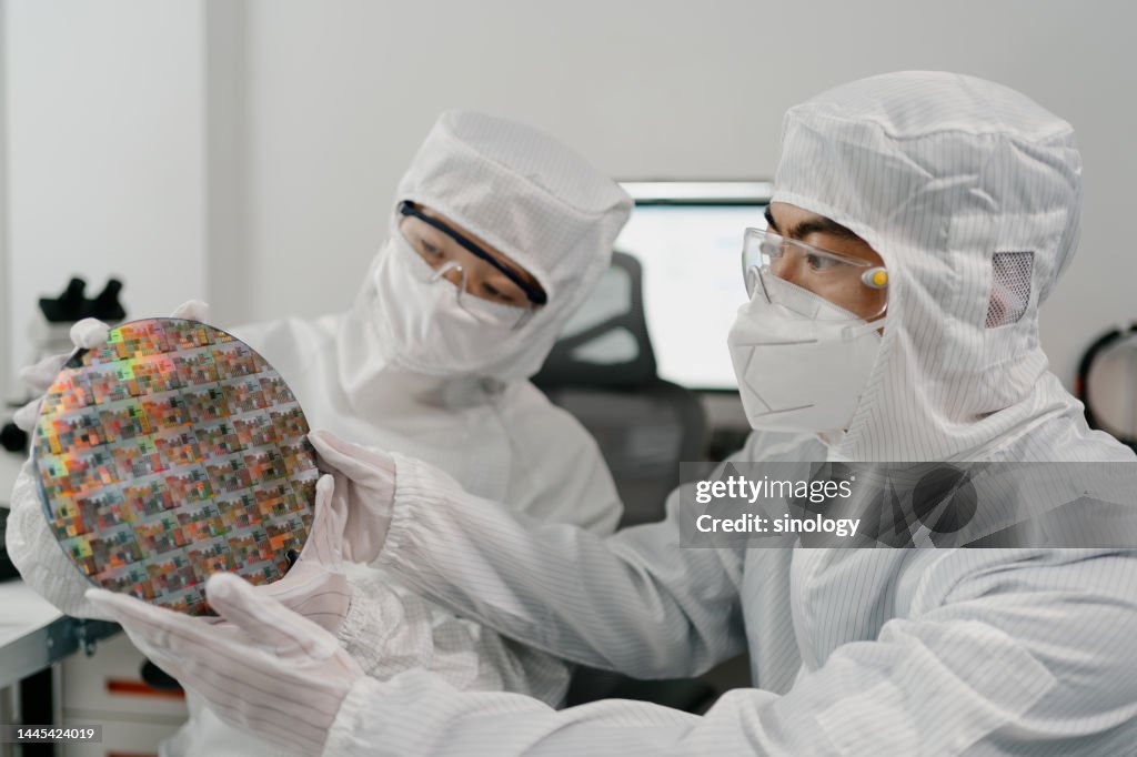 Chip engineer is checking wafer chips