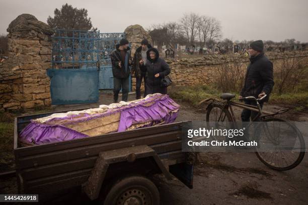The coffin containing the body of a 16-year-old girl sits in a trailer after local residents, police, forensic experts and war crimes prosecution...