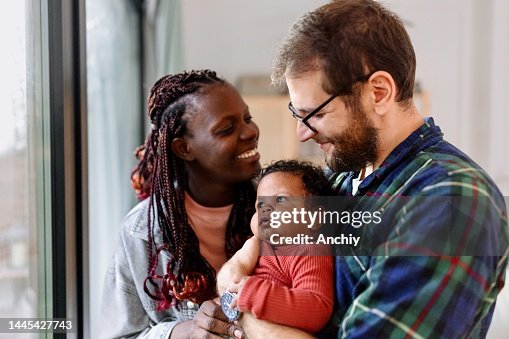 Lovely family enjoying day at home with newborn baby Lovely family enjoying day at home with newborn baby