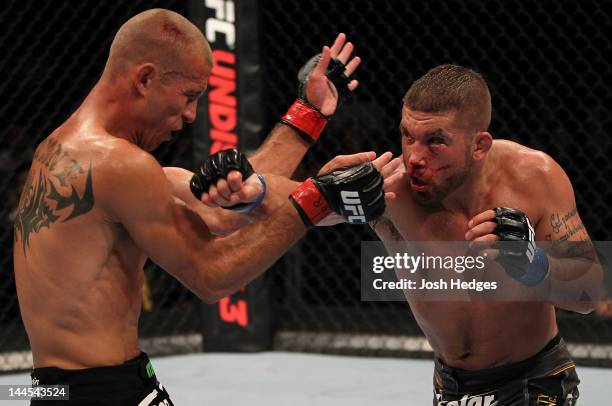 Jeremy Stephens punches Donald "Cowboy" Cerrone in a lightweight bout during the UFC on Fuel TV event at Patriot Center on May 15, 2012 in Fairfax,...