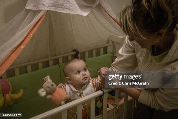 Kherson Regional Children's Hospital Nurse, Tetiana Pavelko plays with her adopted daughter Kira at home on November 28, 2022 in Kherson, Ukraine....