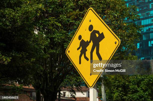 school children crossing traffic warning sign - bogota traffic stock pictures, royalty-free photos & images