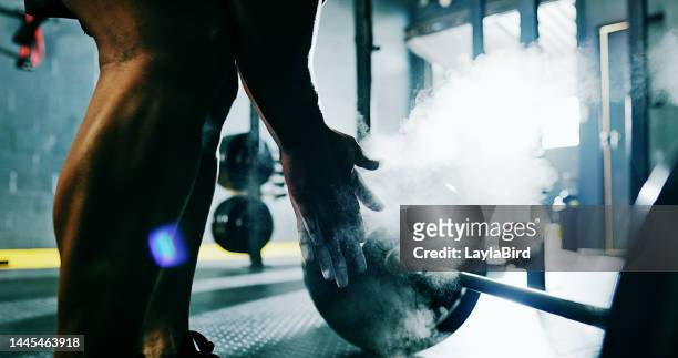 hands, powder and weightlifting with a man bodybuilder in a gym for fitness, exercise or a workout. health, floor and training with a male athlete bodybuilding in a sports club for strong muscles - sports chalk stock pictures, royalty-free photos & images