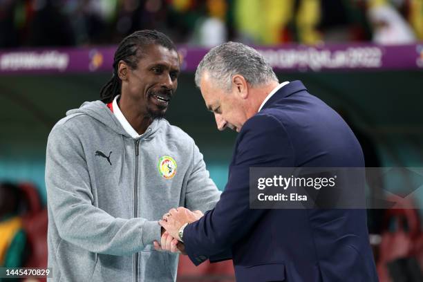 Gustavo Alfaro, Head Coach of Ecuador, shakes hands with Aliou Cisse, Head Coach of Senegal, prior to the FIFA World Cup Qatar 2022 Group A match...