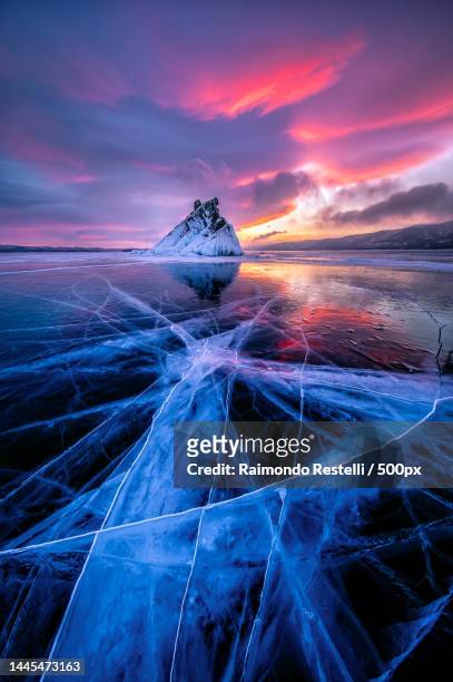 scenic view of frozen sea against sky during sunset,russia - frozen lake sunset stock pictures, royalty-free photos & images