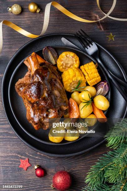 pork shank knuckle with baked potatoes and corn, dinner food christmas new year - christmas leg ham stock pictures, royalty-free photos & images