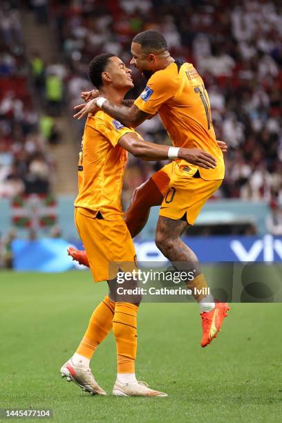 Cody Gakpo of Netherlands celebrates with Memphis Depay after scoring their team’s first goal during the FIFA World Cup Qatar 2022 Group A match...
