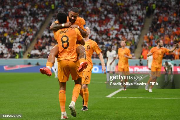 Cody Gakpo of Netherlands celebrates with Memphis Depay after scoring their team’s first goal during the FIFA World Cup Qatar 2022 Group A match...