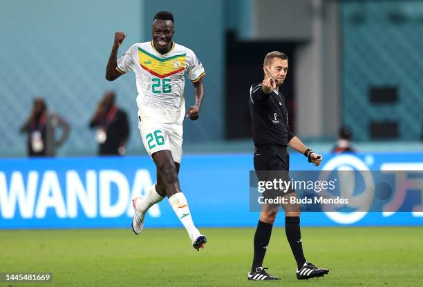 Pape Gueye of Senegal celebrates as referee Clement Turpin points the penalty spot during the FIFA World Cup Qatar 2022 Group A match between Ecuador...