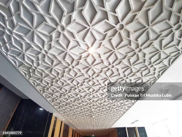 The pattern of a room ceiling with a white relief arrangement with a combination of various shapes and neatly arranged pattern room ceiling with white relief