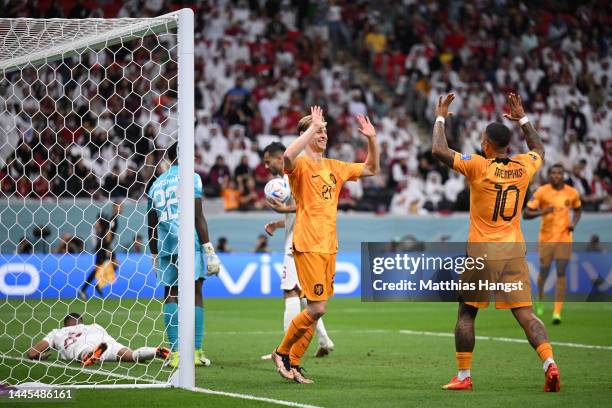 Frenkie de Jong of Netherlands celebrates with Memphis Depay after scoring their team’s second goal during the FIFA World Cup Qatar 2022 Group A...