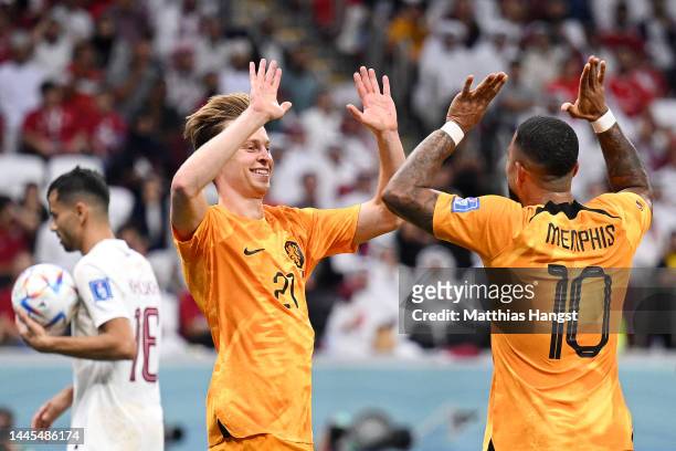 Frenkie de Jong of Netherlands celebrates with Memphis Depay after scoring their team’s second goal during the FIFA World Cup Qatar 2022 Group A...