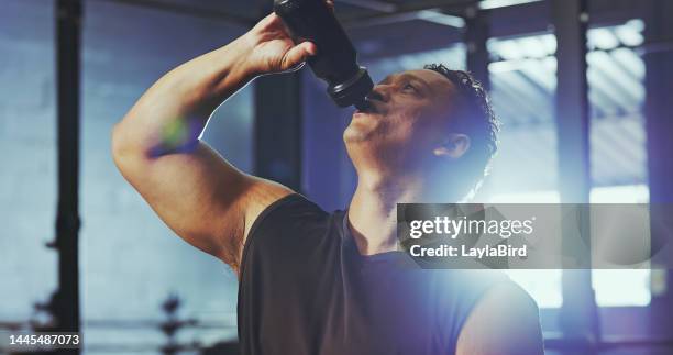 black man, water bottle and exercise in gym for fitness workout, weight training and body building wellness. healthy athlete, protein shake drink and health juice after cardiovascular sports work out - protein drink stock pictures, royalty-free photos & images