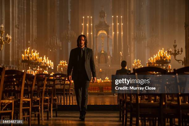 Canadian-born actor Keanu Reeves walks along an aisle in the Church of Saint-Eustache, in a scene from the film 'John Wick: Chapter 4' , Paris,...