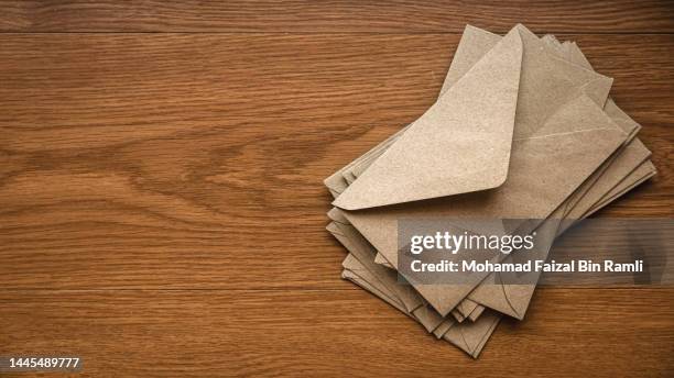 Brown craft envelope on a wooden background. brown craft envelope wooden background