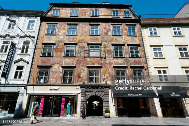 man walking by a beautiful house facade in the historic old center. - estiria austria stock-fotos und bilder