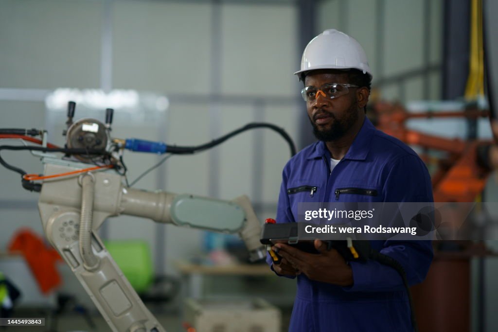 Robotics Control System Engineer Black Engineer Controls Robot Arm Through Application On Tablet High ...