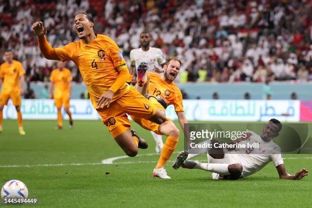 Mohammed Muntari of Qatar fouls Virgil Van Dijk of Netherlands during the FIFA World Cup Qatar 2022 Group A match between Netherlands and Qatar at Al...