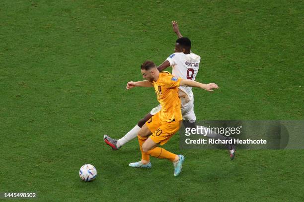 Teun Koopmeiners of Netherlands is challenged by Mohammed Muntari of Qatar during the FIFA World Cup Qatar 2022 Group A match between Netherlands and...