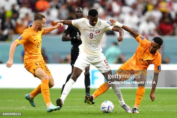 Mohammed Muntari of Qatar controls the ball under pressure of Jurrien Timber and Teun Koopmeiners of Netherlands during the FIFA World Cup Qatar 2022...