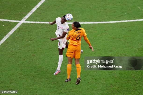 Mohammed Muntari of Qatar and Virgil Van Dijk of Netherlands compete for the ball during the FIFA World Cup Qatar 2022 Group A match between...