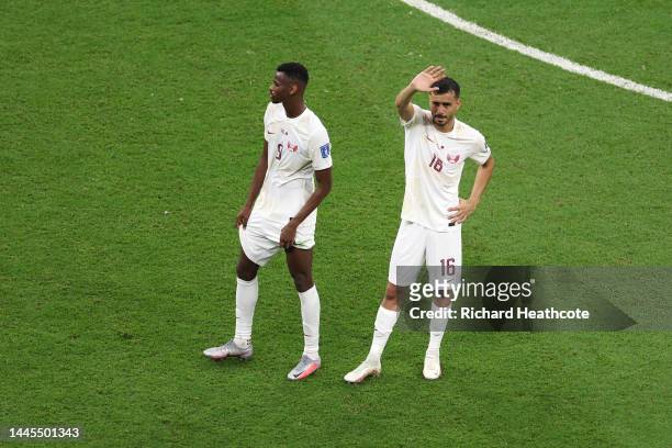 Mohammed Muntari and Boualem Khoukhi of Qatar applaud fans after the 0-2 defeat in during the FIFA World Cup Qatar 2022 Group A match between...