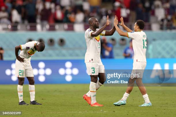 Youssouf Sabaly, Kalidou Koulibaly and Iliman Ndiaye of Senegal celebrate their 2-1 victory in the FIFA World Cup Qatar 2022 Group A match between...