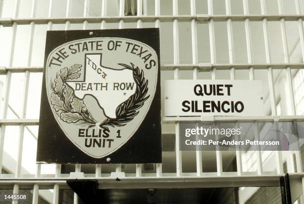 Bilingual sign is attached to cell bars April 15, 1999 at the entrance gate to the Ellis death row unit in Huntsville Prison in Huntsville, Texas....