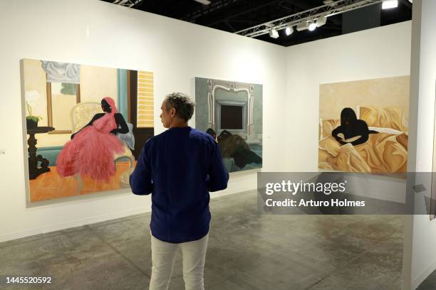 Guests view art on display during Art Basel Miami Beach VIP Preview 2022 at Miami Beach Convention Center on November 29, 2022 in Miami Beach,...