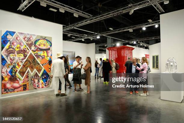 Guests view art on display during Art Basel Miami Beach VIP Preview 2022 at Miami Beach Convention Center on November 29, 2022 in Miami Beach,...