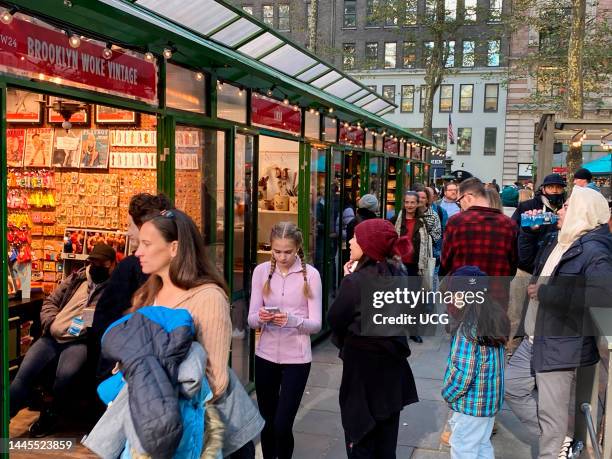 Busy tourism at Bryant Park's Winter Village shopping area, Manhattan, New York.