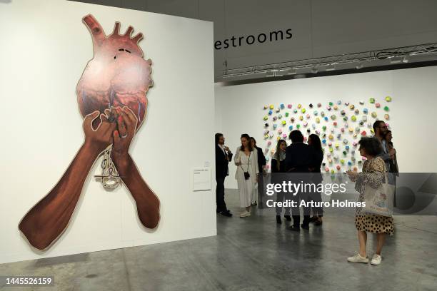 Guests view art on display during Art Basel Miami Beach VIP Preview 2022 at Miami Beach Convention Center on November 29, 2022 in Miami Beach,...