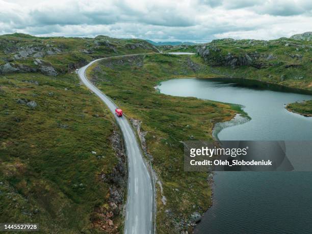 scenic aerial view of camper van on the  road through norwegian highlands - forest road stock pictures, royalty-free photos & images