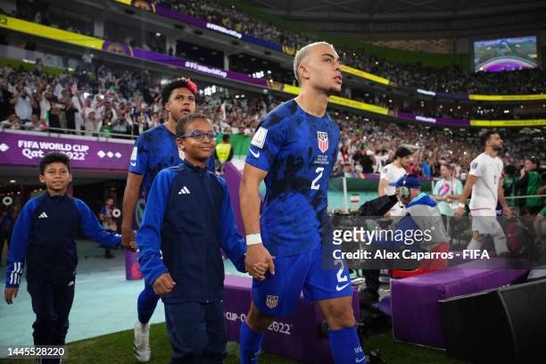Sergino Dest of United States leads their team out prior to the FIFA World Cup Qatar 2022 Group B match between IR Iran and USA at Al Thumama Stadium...