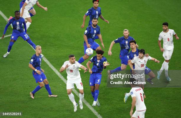 Tyler Adams of United States heads the ball against Majid Hosseini of IR Iran during the FIFA World Cup Qatar 2022 Group B match between IR Iran and...