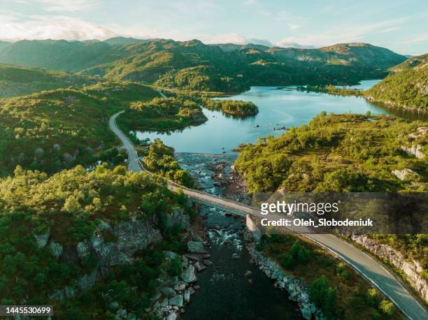 aerial view of  the road near the   lake in norway at sunset - sea road stock pictures, royalty-free photos & images