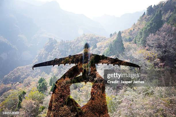 hand holding toy airplane and double exposure - carbon footprint stock pictures, royalty-free photos & images